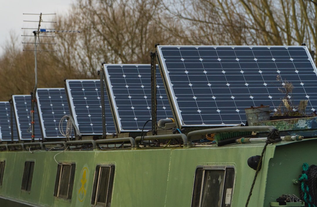 blue-solar-panels-on-green-and-white-bus-zdynmhlduwa